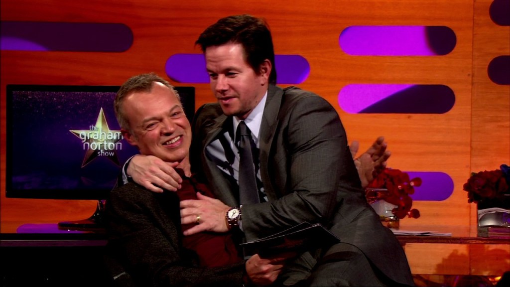 Mark Wahlberg sits on Graham Nortons lap.