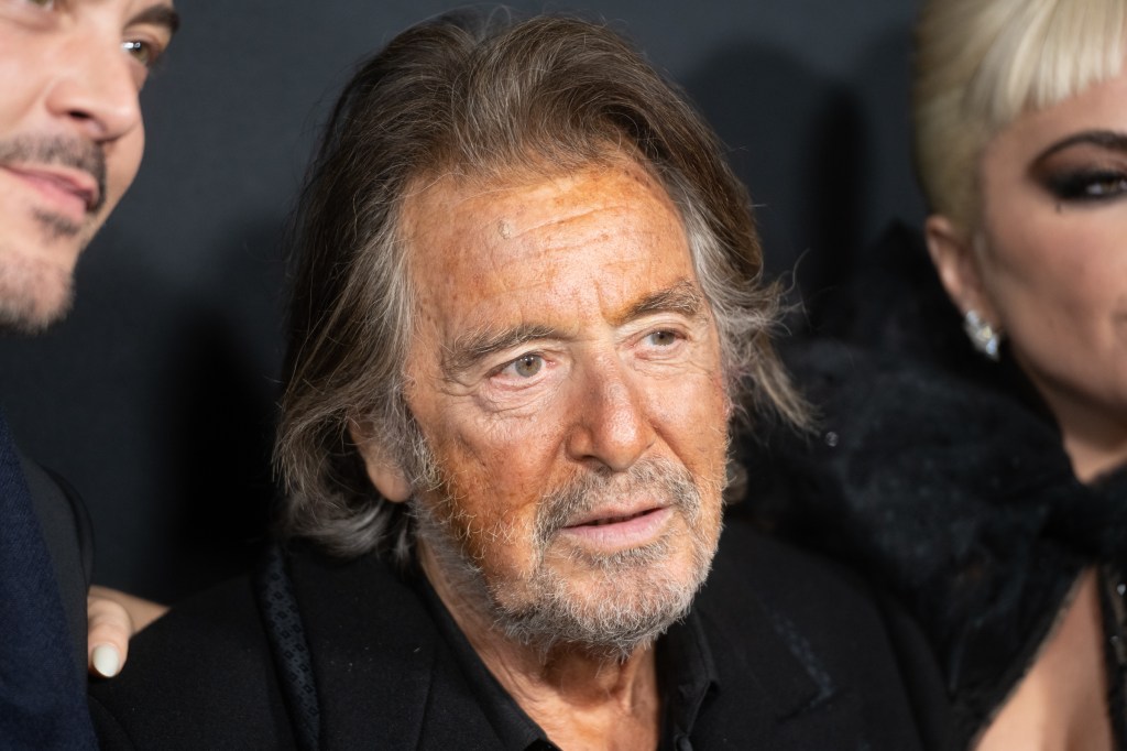 Al Pacino attending a red carpet event wearing a black shirt and suit jacket