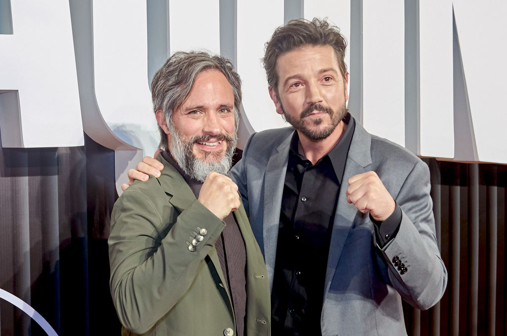 Gael García Bernal and Diego Luna at a red carpet for La Máquina, posing with their fists as punches