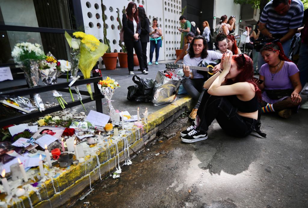 Fans crying in front of tributes to Liam Payne