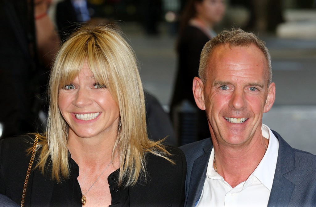 Zoe Ball and Norman Cook smile at an event for a photo