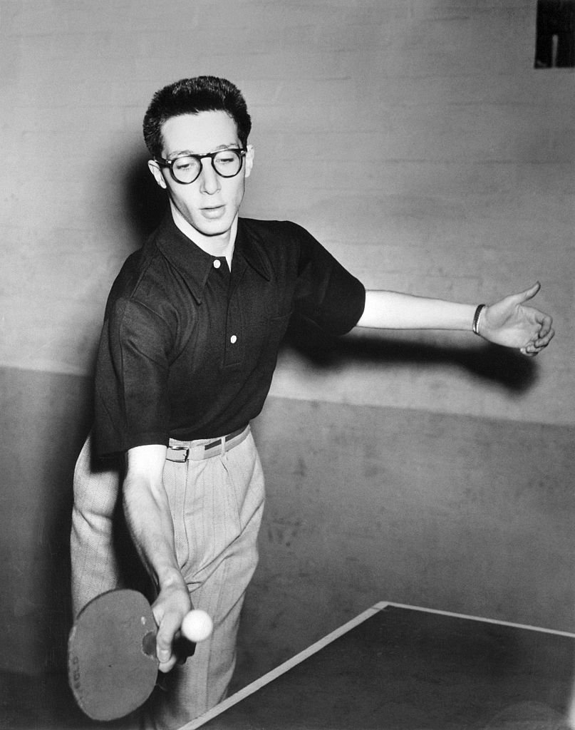 Marty Reisman plays table tennis in black and white photo