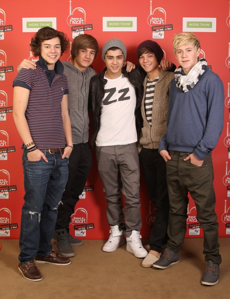 One Direction members Harry Styles, Liam Payne, Zayn Malik, Louis Tomlinson, and Niall Horan posing together at an event