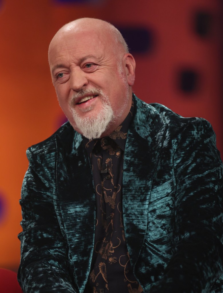 Bill Bailey smiling on The Graham Norton Show, wearing a dark green velvet jacket