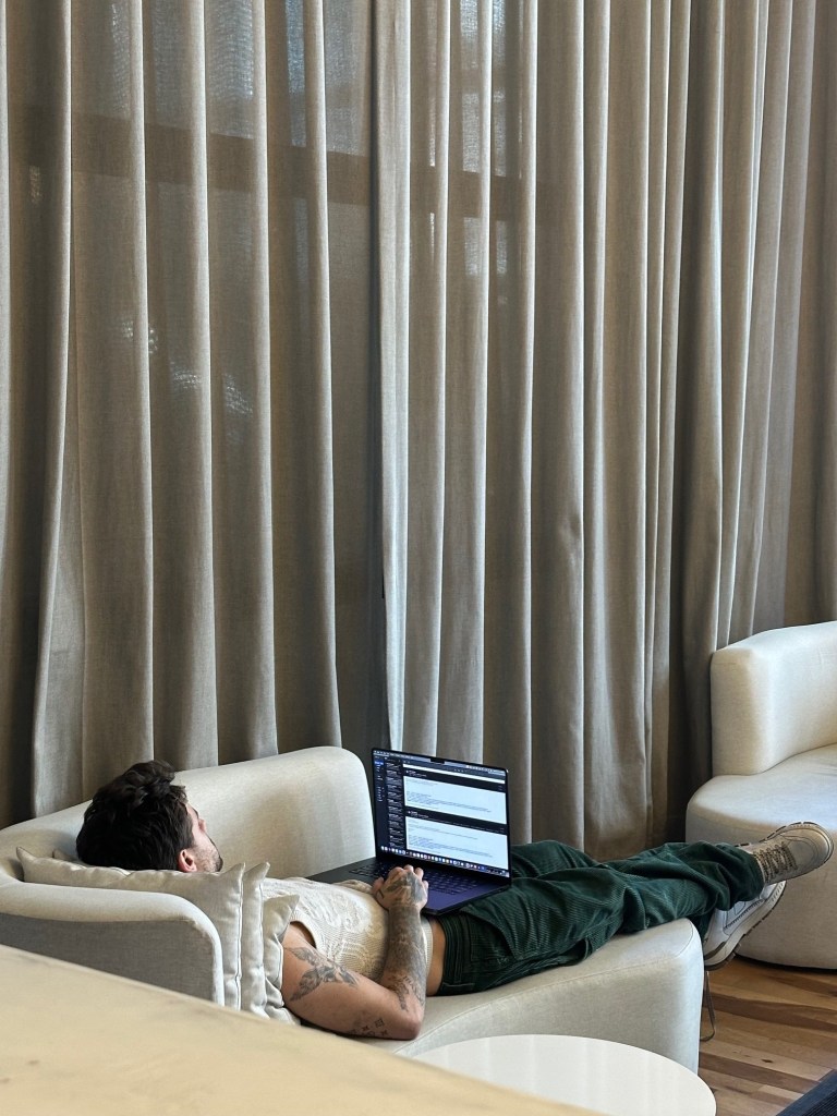 Liam Payne pictured laying on a couch on his laptop by someone staying at the CasaSur Palermo Hotel in Buenos Aires, Argentina. 