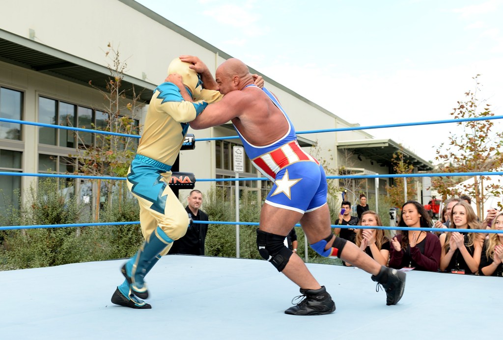 Liam Payne (L) and Kurt Angle grapple in the ring during One Direction celebrates 1D Day at YouTube Space LA