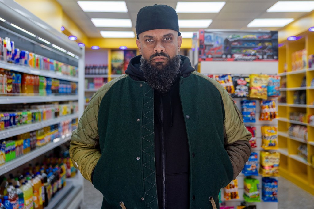 Guz Khan stands in a corner shop during a scene from Man Like Mobeen.