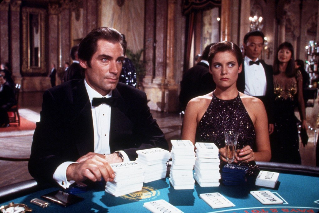 Timothy Dalton and Carey Lowell in James Bond movie Licence to Kill, sitting at a card table