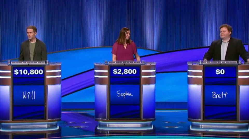 Bad Santa star Brett Kelly on Jeopardy!, standing behind podiums next to two other contestants