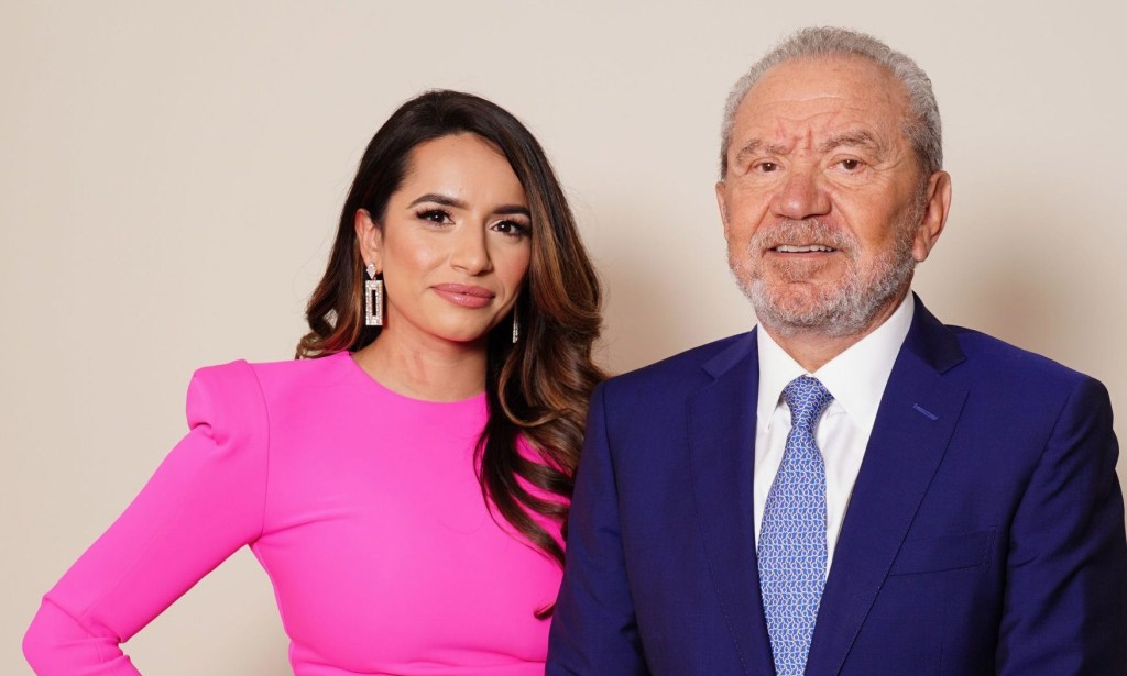 The Apprentice 2022 winner Harpreet Kaur and Lord Alan Sugar posing together. She wears a bright pink dress while he wears a blue suit