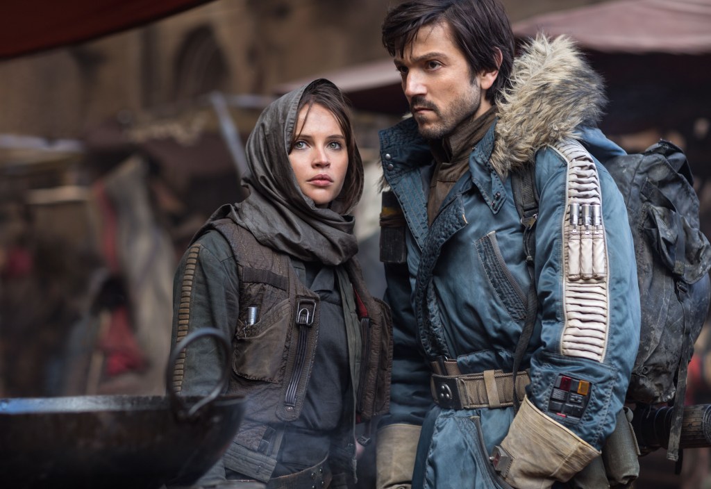 Felicity Jones and Diego Luna in Rogue One: A Star Wars Story, both looking serious